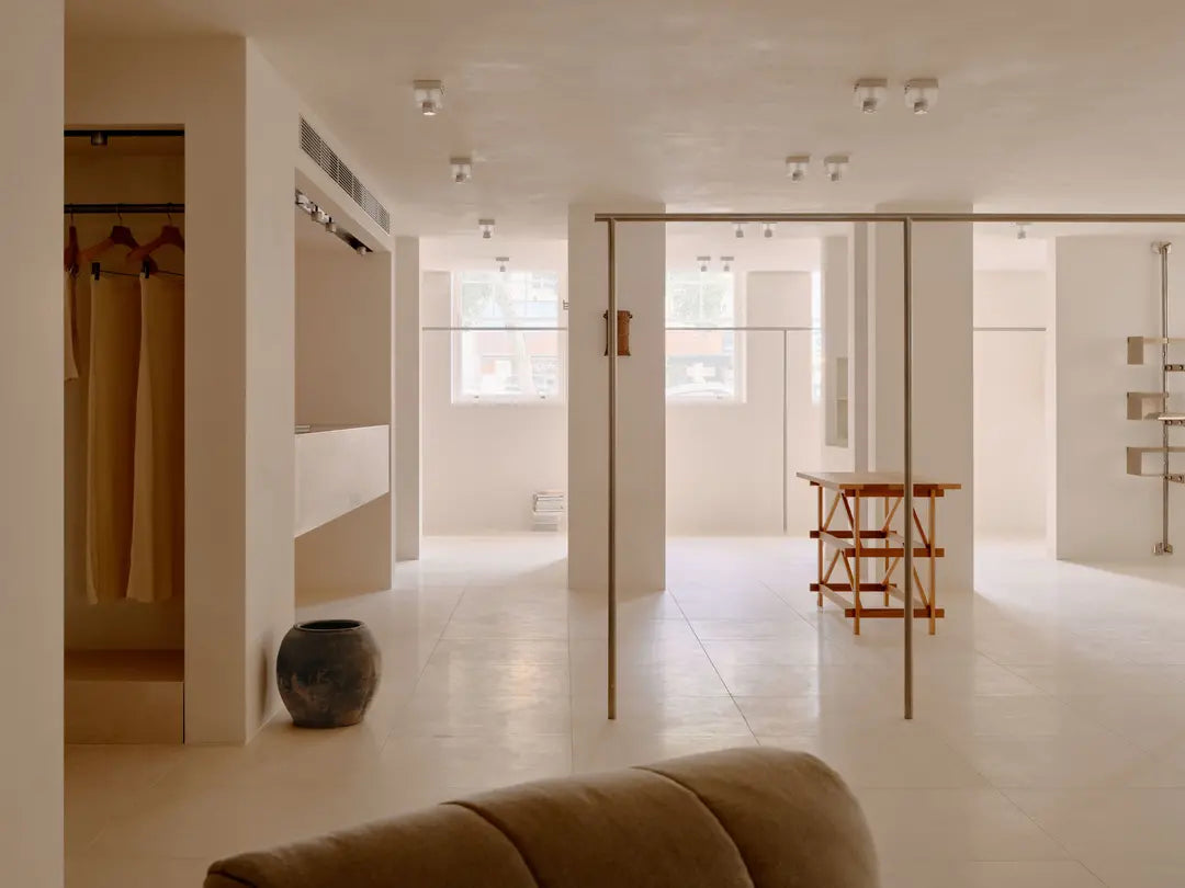 Modern interior with a couch, mirror, and minimal decor.