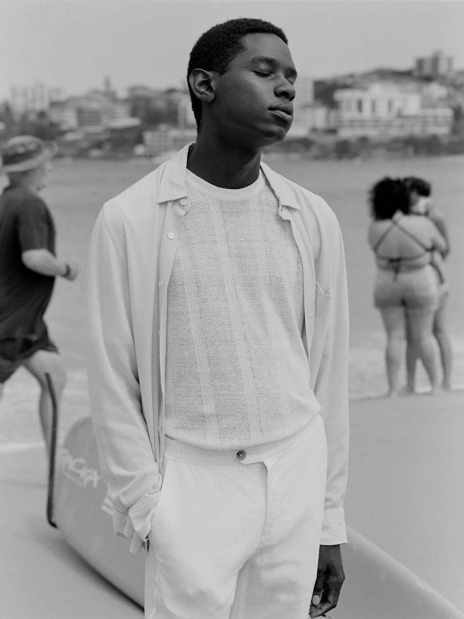 Man standing on a beach with people